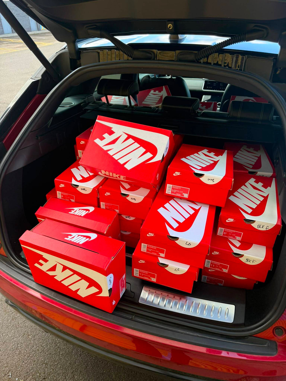 Car boot loaded with Nike boxes